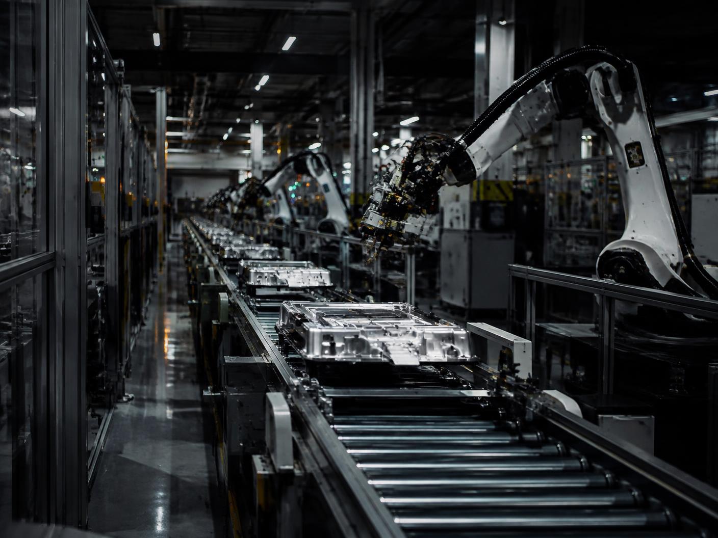 Automated production line with conveyor systems and robotic equipment inside a factory